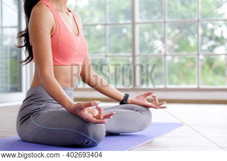 Close Up Of Woman Practice Yoga Meditation Exercise At Home, Young Female Sitting On Mat For Relaxed