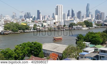 Financial District Near Calm River. View Of Skyscrapers Located On Shore Of Tranquil Chao Praya Rive