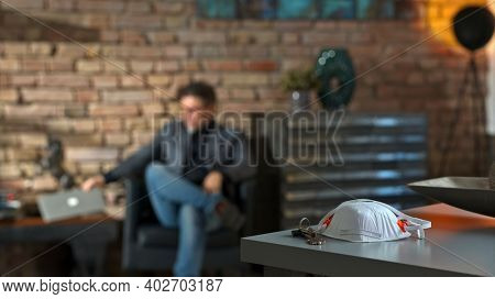 Covid-19 virus danger - Businessman working at safety of home office leaving virus protective mask on desk.
