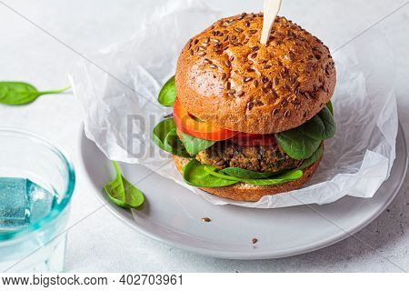 Vegan Lentil Burger With Baked Sweet Potato, Tomato Sauce And Fresh Vegetables On A Gray Plate. Vega