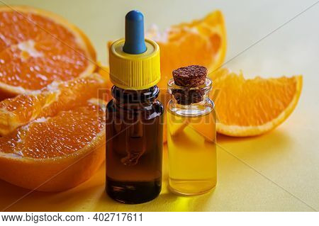 Orange Essential Oil On A Yellow Background. Selective Focus.