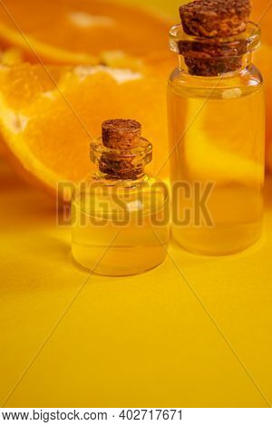 Orange Essential Oil On A Yellow Background. Selective Focus.