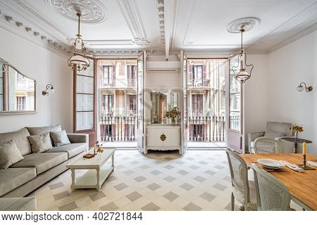 Front View To The Retro Style Living Room, With Dining Table, Sofa, Tile Floor, Vintage Chandeliers 