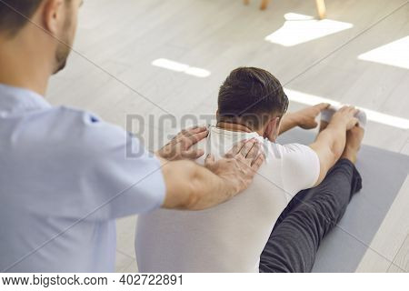 Man Professional Doctor Osteopath Fixing And Stretching Mans Back During Exersicing