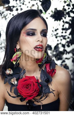 Pretty Brunette Woman With Rose Jewelry, Black And Red, Bright Make Up Kike A Vampire Closeup Red Li