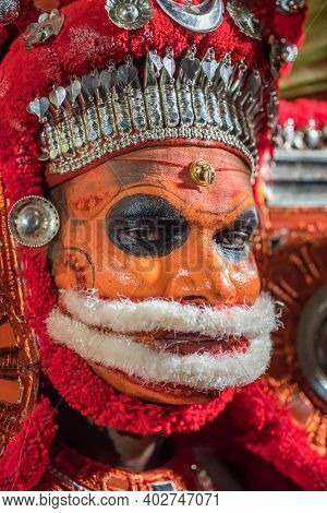 Payyanur, India - December 5, 2019: Portrait of an unidentified Theyyam dancer during temple festival in Payyanur, Kerala, India. Theyyam is a popular ritual form of worship in Kerala, India