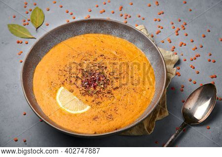 Ezogelin Soup In Gray Bowl On Concrete Table Top. Turkish Cuisine Traditional Dish With Red Lentils,