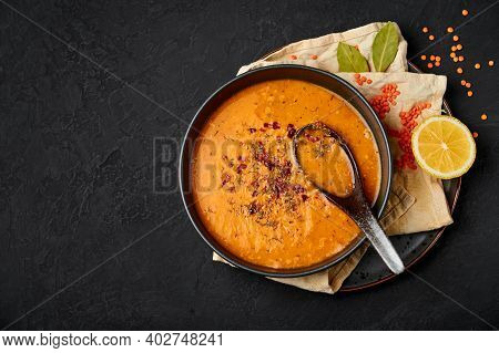Ezogelin Soup In Black Bowl On Dark Slate Table Top. Turkish Cuisine Traditional Dish With Red Lenti