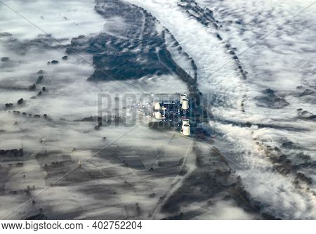 Aerial Of Rhine Valley Landscape In Morning Fog With Electric Pylons And Atomic Power Plant Biblis