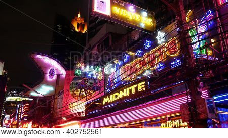 Bangkok, Thailand, 13 July 2019: Vivid Neon Signs Glowing On Soi Cowboy Street. Nightlife In Erotic 