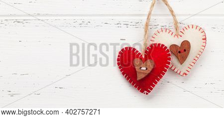 Valentines day greeting card template. Heart shaped decor over white wooden background. Top view flat lay with copy space