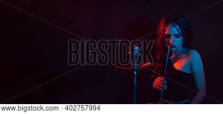 A Young Girl Enjoys Smoking A Hookah, Sheesha. Photo With Space For Text