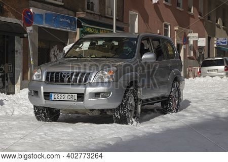 Madrid, Spain - January 10, 2021: An Off-road Vehicle Slowly Travels Down A Street In The Retiro Dis