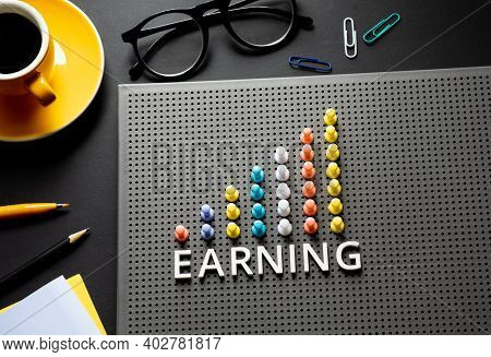 Earning text with pin garph chart on business table.vision to success and strategy plan.