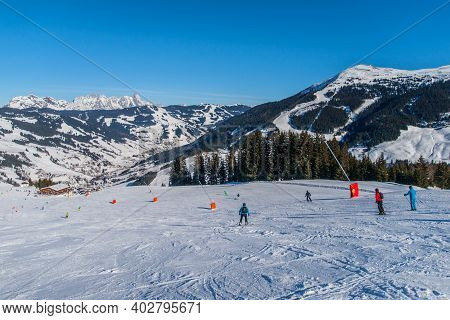Downhill Skiers On Slope In Apline Ski Resort. Active Vacation On Sunny Winter Day, Hinterglemm, Aus