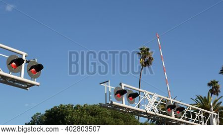 Level Crossing Warning Signal In Usa. Crossbuck Notice And Red Traffic Light On Rail Road Intersecti