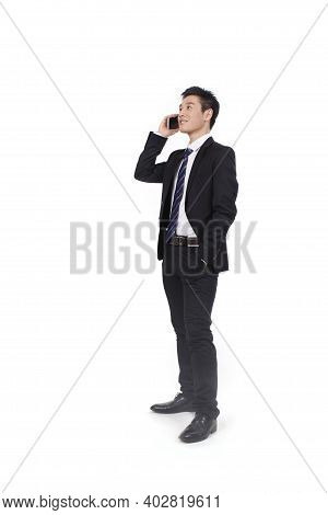 Portrait Of A Businessman Standing With Cellular Phono High Quality Photo