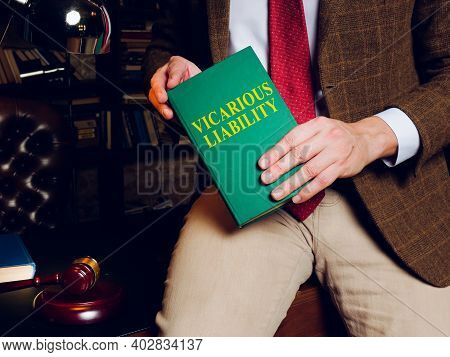 A Lawyer Holds A Book About Vicarious Liability.