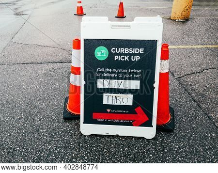 Toronto, Ontario, Canada - January 3, 2021: Street Sign Saying Contactless Curbside Pickup Available