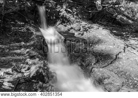 Long Exposure Of A Man Made Waterfall At Canonteign Falls In Dartmoor