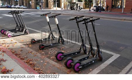 San Diego, California Usa - 4 Jan 2020: Row Of Ride Sharing Electric Scooters Parked On Street In Ga