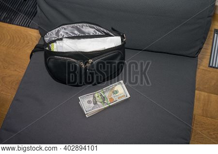 Us Dollars Baknotes And Handbag On An Armchair, Indoor Closeup