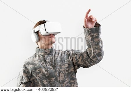 Soldier in VR headset touching virtual screen for simulation training military technology