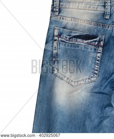 Back Pocket And Waist Area Of Light Blue Jeans With Faded White Spots, Isolated On White Background.