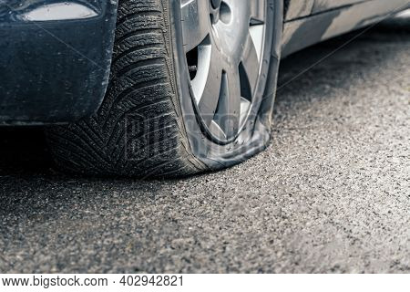 flat car tire close up, punctured wheel
