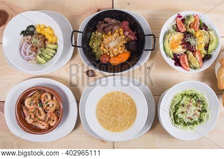 Set With Dishes From Spanish Bar Poke Bowl, Cozido Madrileno, Gambas, Tagliatelle, Salad With Goat C