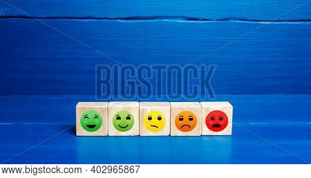 Mood Faces From Happy To Angry On Wooden Blocks. Concept Of Rating, Review. Visitor Satisfaction Wit