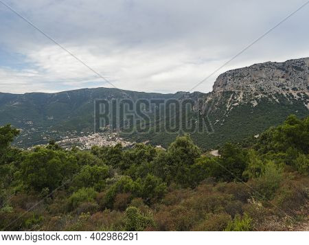 Aerial View Of Green Landscape Of Supramonte Mountains With Urzulei Town, Limestone Rock And Mediter