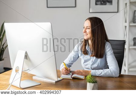 Happy Female Office Employee In Smart Casual Wear Dreaming And Planning Smth, Going To Take A Note I