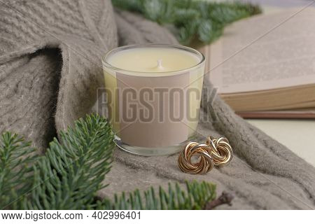 Eco-friendly Handmade Soy Wax Candle In A Glass Candlestick. Nearby Lies A Decor Of Fir Branches, A 