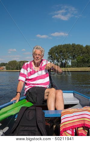 Elderly man in boat at the river