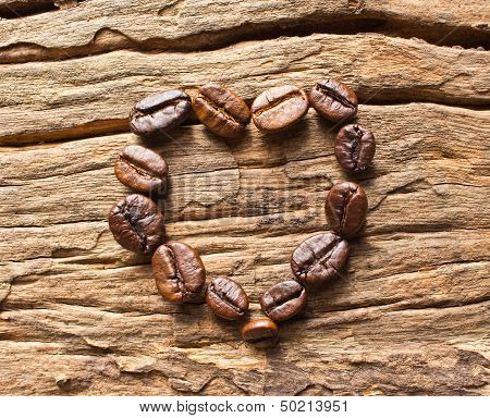 Coffee Beans In A Heart Shape On Wood