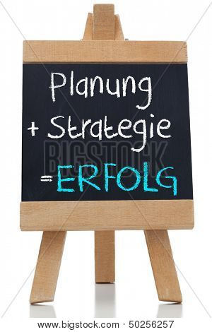 Planning strategy written on blackboard in german on white background