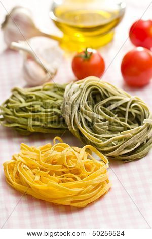 Italian pasta tagliatelle on checkered tablecloth