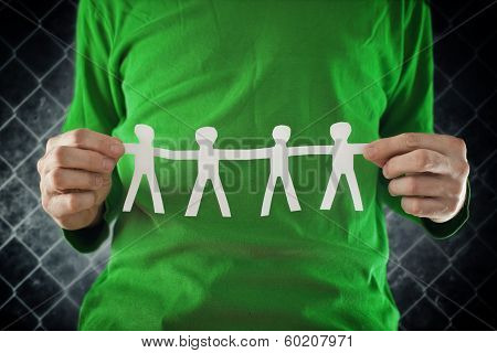 Man Holding Chain Of People Paper Cuts