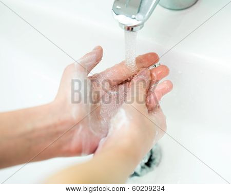 Close-up Of Kid Hands Under Stream Of Water From Faucet