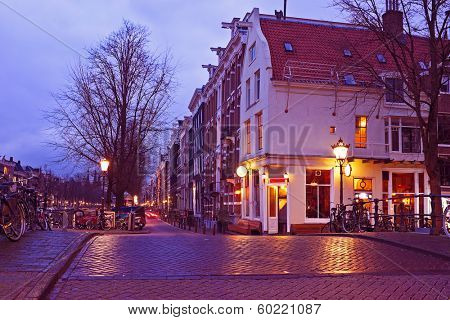 Streetview with amsterdam cafe in the Netherlands by twilight