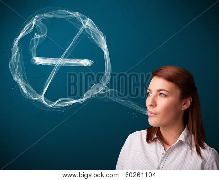 Pretty young lady smoking unheathy cigarette with no smoking sign