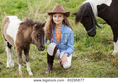 Little foal - cute girl takes care of the pony foal
