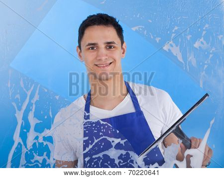 Male Servant Cleaning Glass With Squeegee
