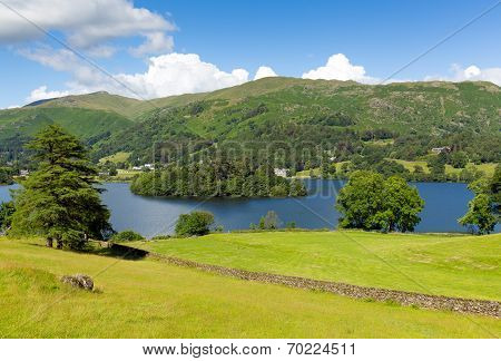 Grasmere Lake District Cumbria England UK with blue sky mountains and white clouds