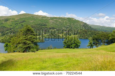 Grasmere Lake District Cumbria England UK with blue sky mountains and white clouds