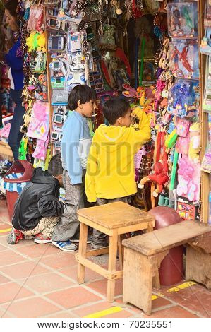 Children at Toy Stand in Banos, Ecuador