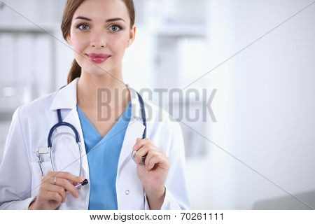 Portrait of happy successful young female doctor holding a stet