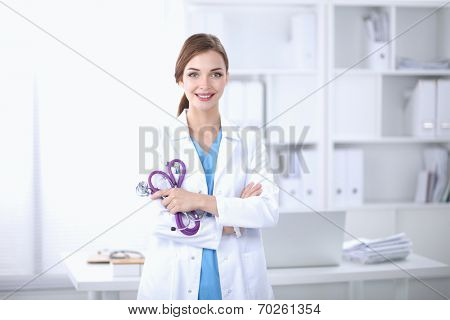 Portrait of happy successful young female doctor holding a stet