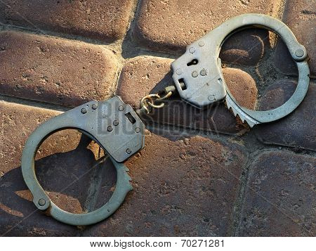 Handcuffs On A Stone Floor.
